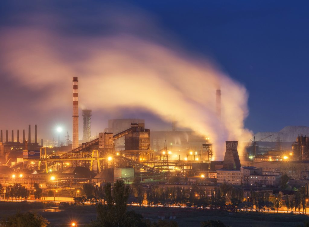 Metallurgical plant at night. Steel factory with smokestacks